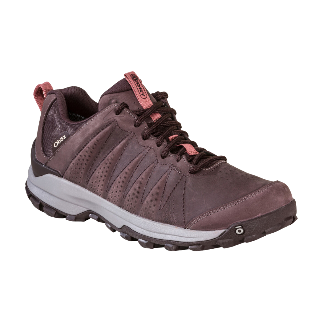 Angled view of Women’s Oboz Sypes Low Waterproof in Peppercorn – featuring a waterproof nubuck leather and mesh upper, B-DRY waterproof membrane for moisture protection, EVA midsole for cushioned support, and a muted peppercorn grey tone for versatile outdoor wear.