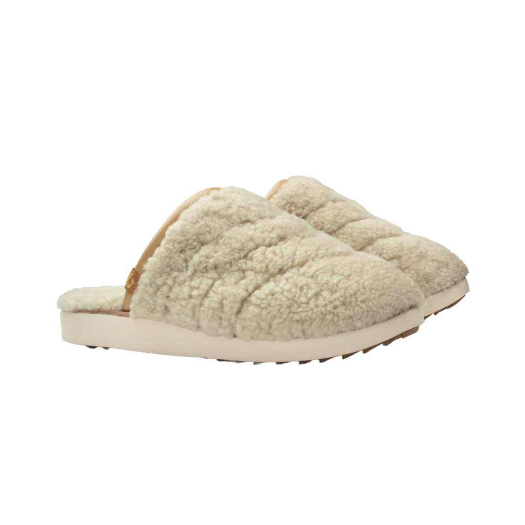 Side view of Women’s Olukai Pūpū Mua slip-on in Tapa – made with canvas upper, collapsible heel, and cushioned midsole with wet-grip rubber traction.