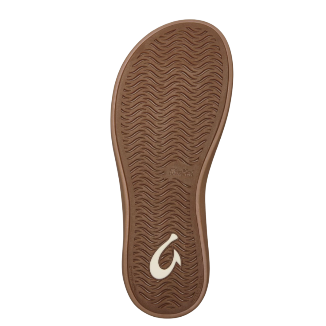 Bottom view of Women’s Olukai Kapehe Luana sandal in Silver/Sahara – features include a non-marking rubber outsole with textured tread for grip, floral-inspired traction design, and color-contrasting sole for visual appeal.