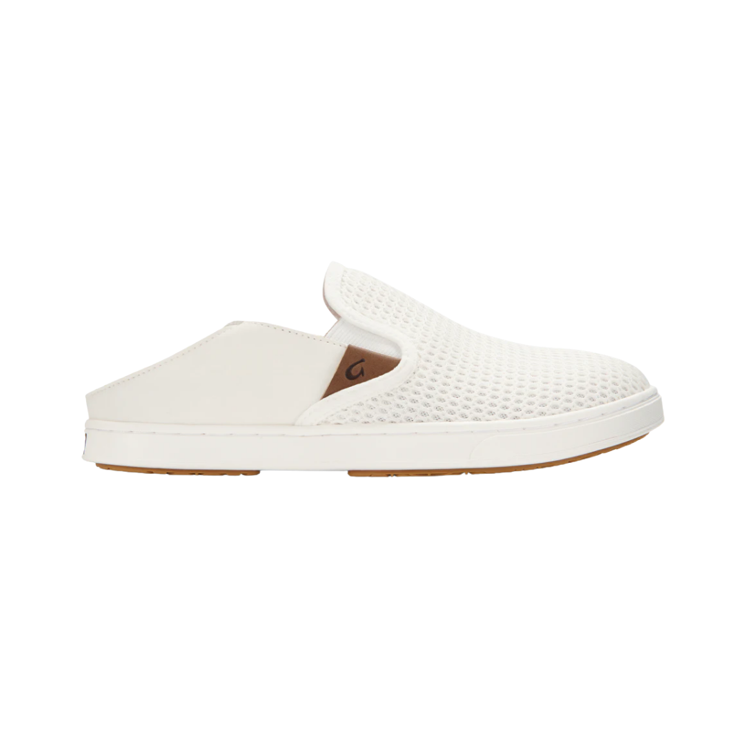 Side View of Women’s Olukai Pehuea slip-on sneaker in bright white – featuring breathable mesh upper, cushioned dual-density footbed, and lightweight rubber outsole for all-day comfort.