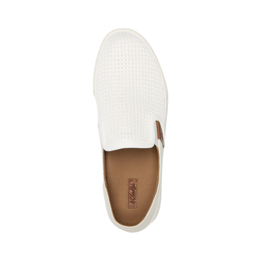 Top View of Women’s Olukai Pehuea slip-on sneaker in bright white – featuring breathable mesh upper, cushioned dual-density footbed, and lightweight rubber outsole for all-day comfort.