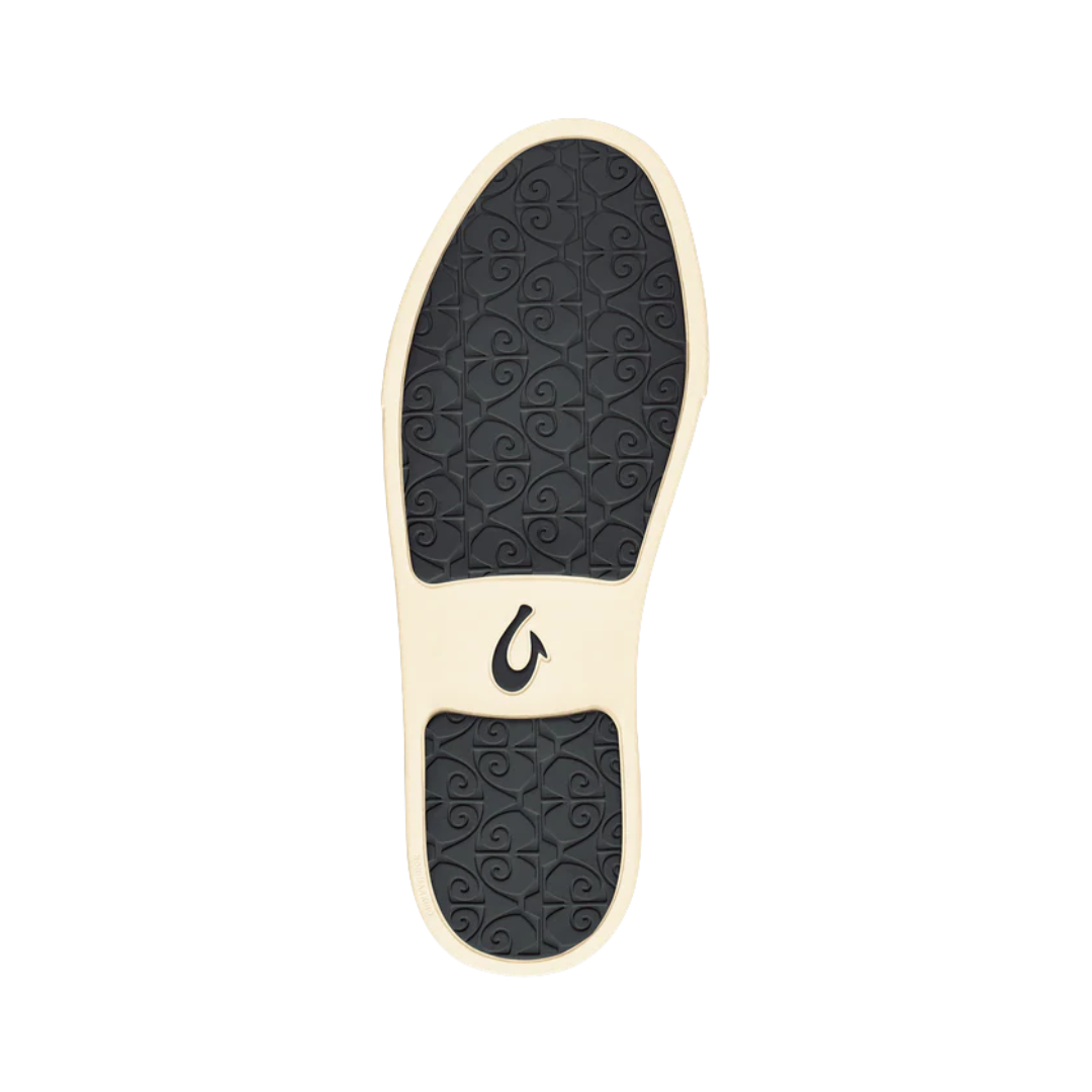 Bottom View of Women’s Olukai Pehuea slip-on sneaker in pavement – featuring a durable non-marking rubber outsole, enhanced traction pods, and flexible support for versatile wear.