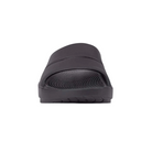 Front view of Unisex OOFOS Ooahh Slide Sandal in black – featuring a wide, seamless synthetic strap, anatomically molded footbed, subtle textured surface for grip, and a clean, minimal look in solid black.