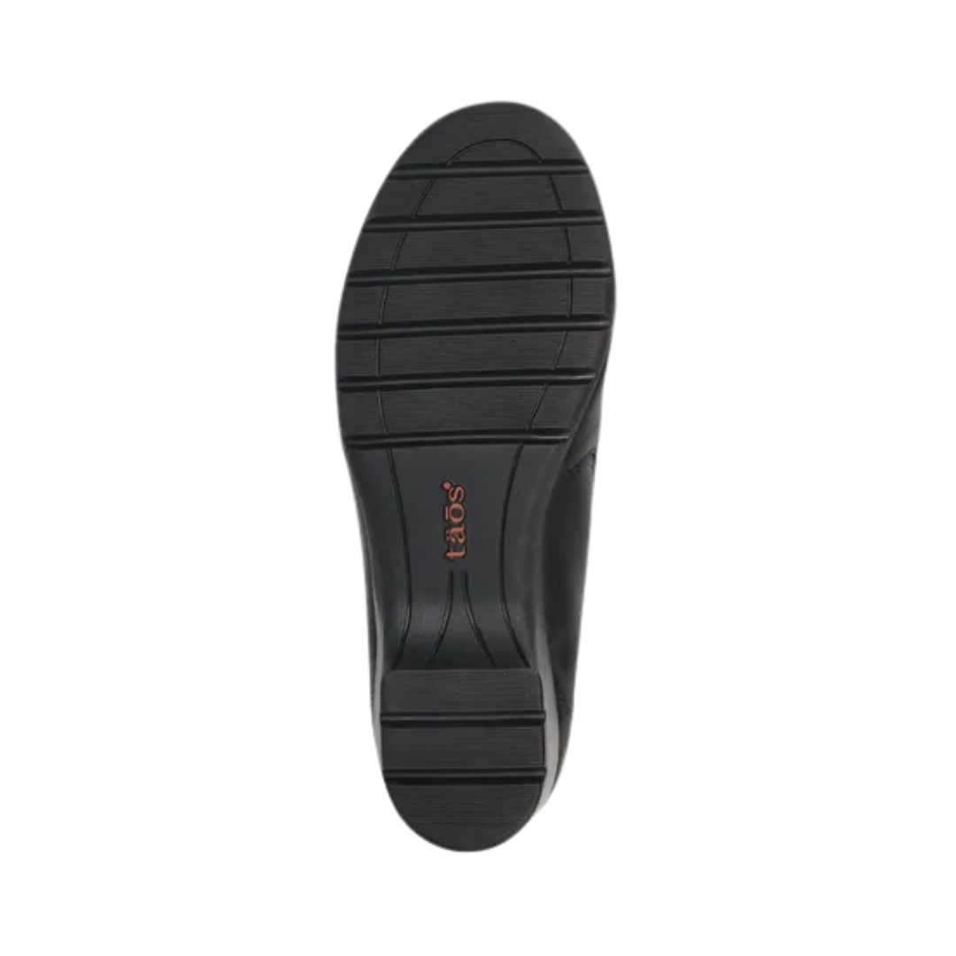 Bottom View of Women’s Taos Daily Shoe in Black – featuring a durable slip-resistant rubber outsole, flexible tread pattern for traction, and a lightweight construction for all-day wear.