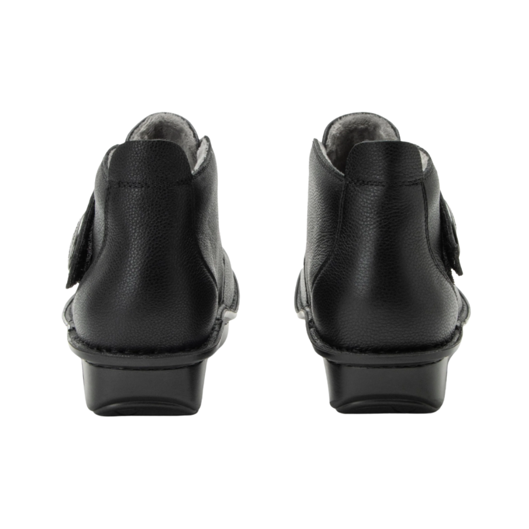 Bottom View of Women’s Alegria Caiti boot in upgrade black – featuring a slip-resistant patterned outsole, durable tread design, and lightweight construction for secure footing.
