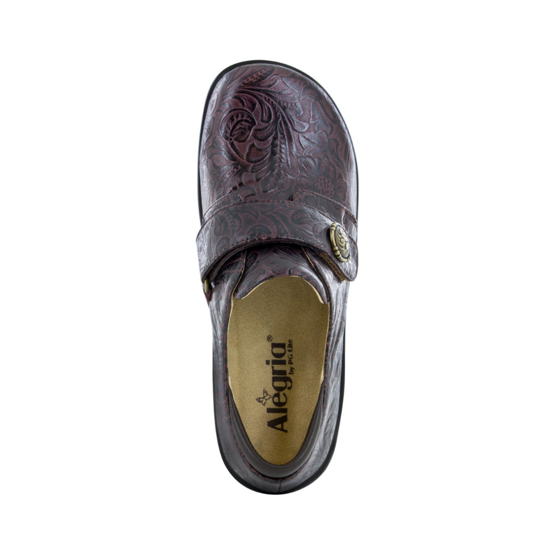 Top View of Women’s Alegria Joleen shoe in molasses tooled brown – featuring a cushioned removable footbed, textured leather upper, and adjustable hook-and-loop strap for a secure fit.