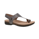 Side view of the Women’s Dansko Reece Sandal in Pewter Metallic, featuring a soft genuine leather upper with an adjustable hook-and-loop strap, a minimalist silhouette, and a lightweight rubber outsole. Designed with Dansko Natural Arch Technology and a molded EVA footbed for all-day support and comfort.