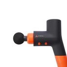 Side View of Jawku Muscle Blaster Mini in black and orange – featuring a round massage head attachment, dual control buttons on the side, and compact ergonomic design for targeted muscle therapy.