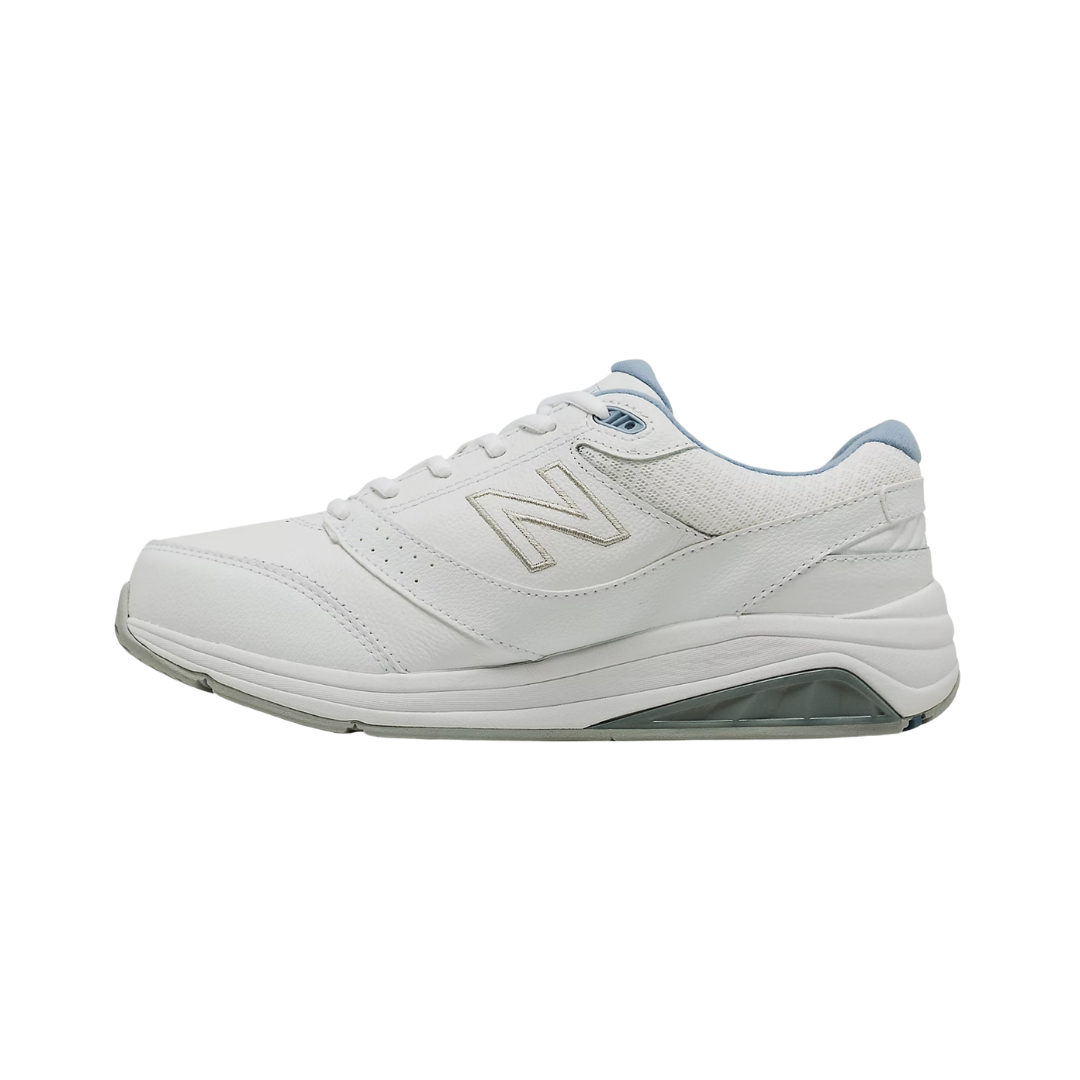 Side View of Women’s New Balance 928v3 walking shoe in white with blue – featuring a motion-control midsole, ABZORB cushioning for shock absorption, and a supportive heel counter to promote alignment and reduce overpronation.
