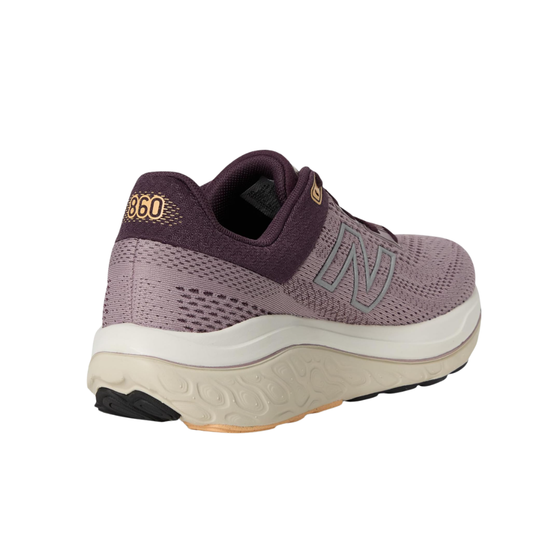 Angled view of Women’s New Balance Fresh Foam X 860v14 in Ice Wine/Plum Brown/Silver Metallic – featuring lightweight construction, supportive cushioning, and durable outsole suitable for running activities.