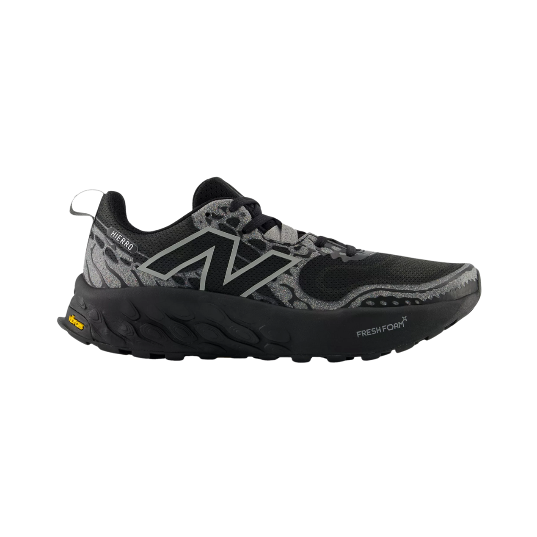Side View of Men’s New Balance Fresh Foam X Hierro v8 trail running shoe in black with shadow grey – featuring rocker-style sole geometry for smoother heel-to-toe transitions, Fresh Foam cushioning for impact reduction, and medial support to help align the foot properly.