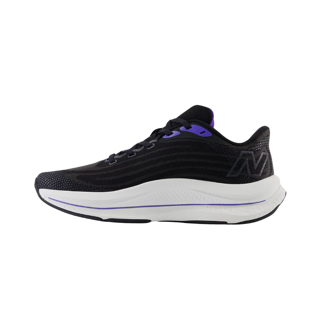 Side View of Women’s New Balance FuelCell Walker Elite walking shoe in black with electric indigo and grey violet – featuring sculpted FuelCell cushioning, logo-accented side panel, and supportive heel structure.