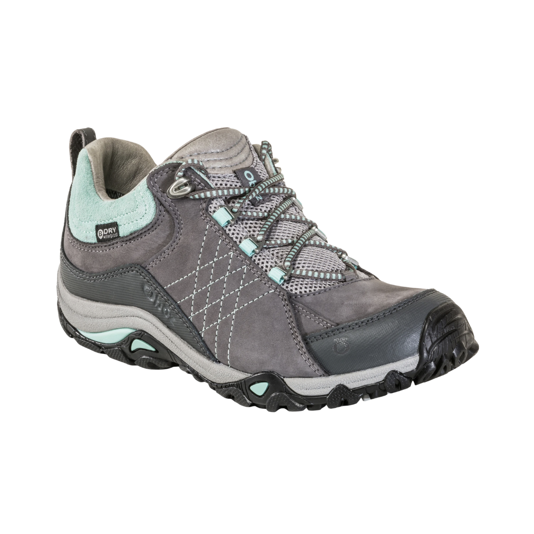 Side view of women’s Oboz Sapphire Low hiking shoe in Charcoal Beach gray/tan blend with waterproof mesh and leather upper, cushioned midsole, and grippy multi-terrain outsole.