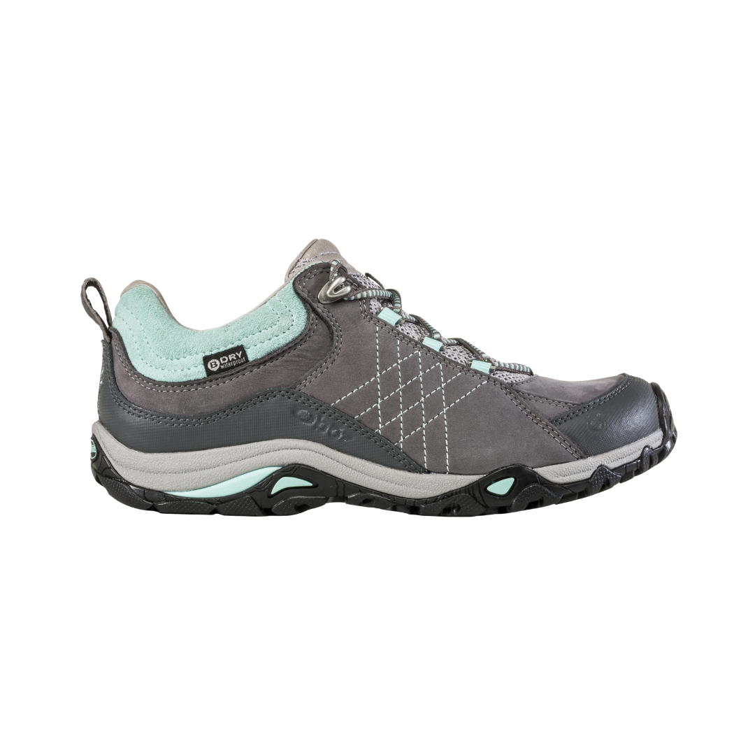Side View of Women’s Oboz Sapphire Low Waterproof Hiking Shoe in Charcoal/Beach – featuring a low-cut profile for lightweight flexibility, dual-density EVA midsole for shock absorption, and reinforced toe protection for rugged trail conditions.