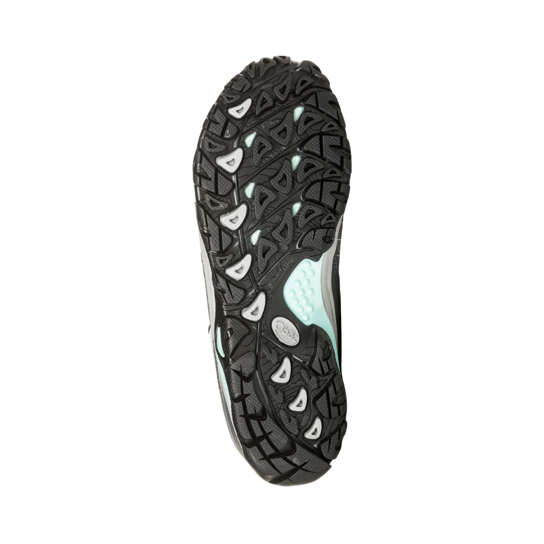 Bottom View of Women’s Oboz Sapphire Low Waterproof Hiking Shoe in Charcoal/Beach – featuring a Swiftcurrent rubber outsole with multi-directional lugs for reliable trail traction, a durable midfoot shank for stability, and slip-resistant grip on varied terrain.