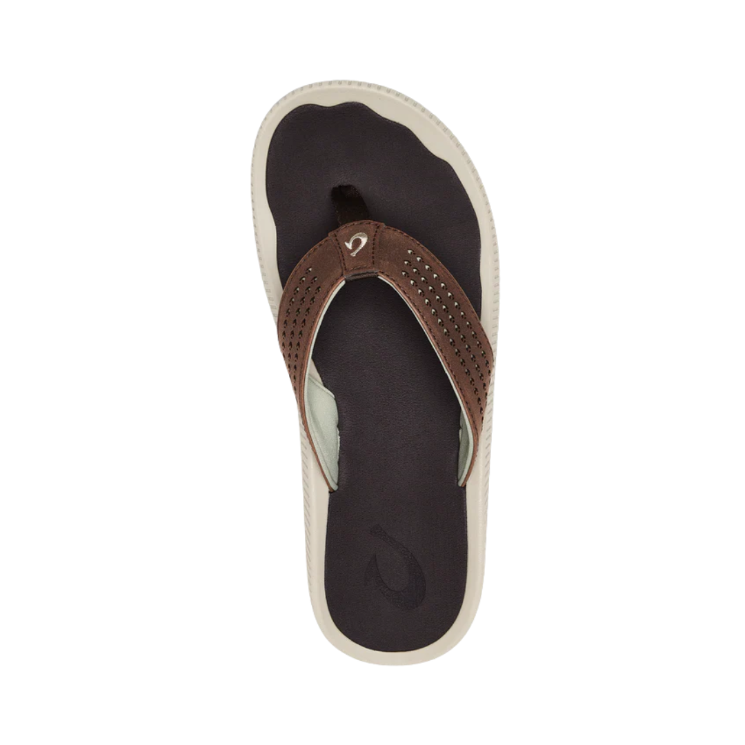 Top View of Men’s Olukai Ulele sandal in dark wood – featuring a water-resistant synthetic upper, soft microfiber lining for comfort, and a non-marking wet-grip rubber outsole.